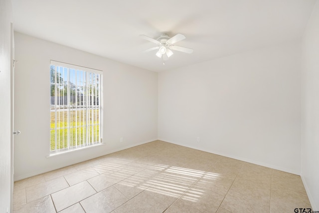 tiled empty room with ceiling fan