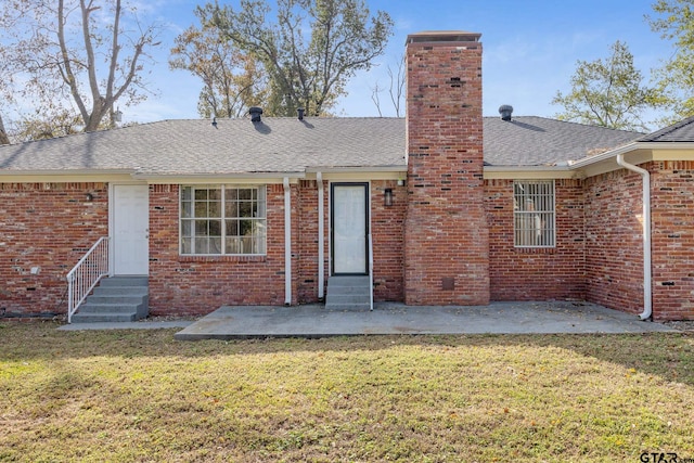 back of house featuring a yard and a patio area