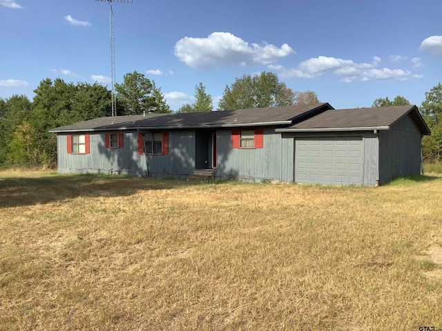 single story home with a front yard and a garage