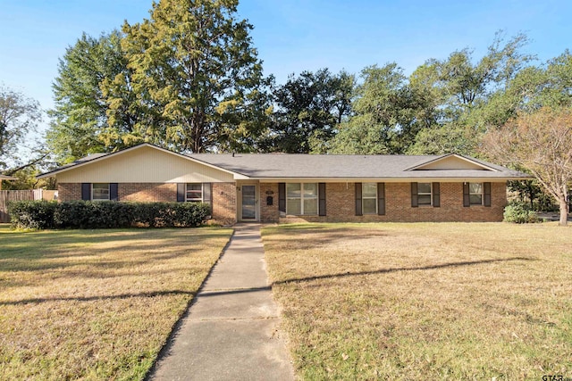 single story home with a front lawn and brick siding