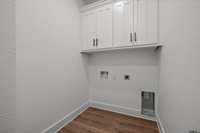 laundry area featuring washer hookup, dark hardwood / wood-style floors, cabinets, and electric dryer hookup