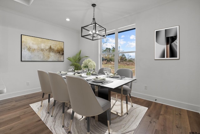 dining room featuring a chandelier, ornamental molding, and dark wood-type flooring