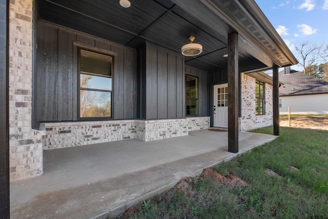 view of exterior entry with covered porch