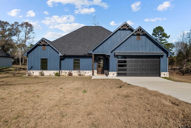 view of front of house featuring a front yard and a garage