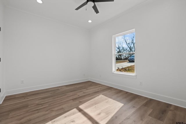 unfurnished room with ceiling fan, crown molding, and wood-type flooring