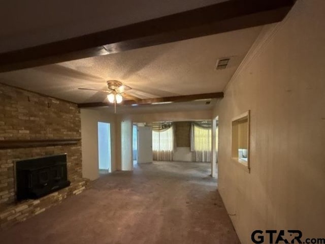 3606 Glendale Dr, Tyler, TX 75701 - unfurnished living room with ceiling fan, beam ceiling, a brick fireplace, and carpet floors