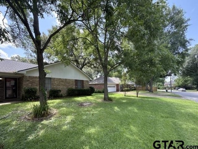 3606 Glendale Dr, Tyler, TX 75701 - view of green lawn with a garage
