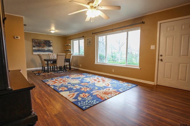 dining space with dark wood-type flooring, ceiling fan, and ornamental molding