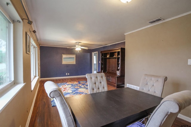 dining space featuring ornamental molding, dark wood-type flooring, and ceiling fan