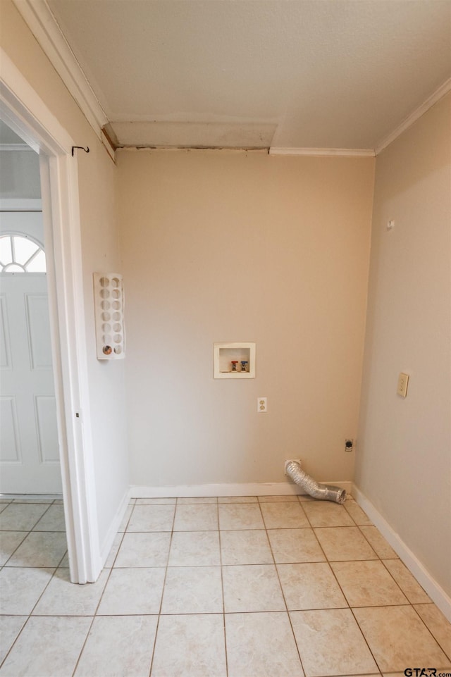 laundry room featuring crown molding, washer hookup, and light tile patterned flooring