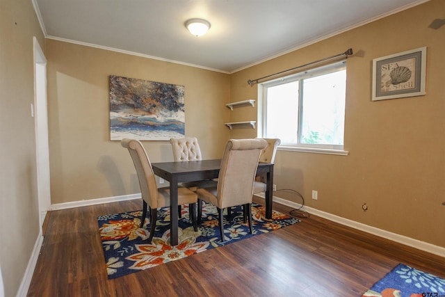 dining room with ornamental molding and dark hardwood / wood-style flooring