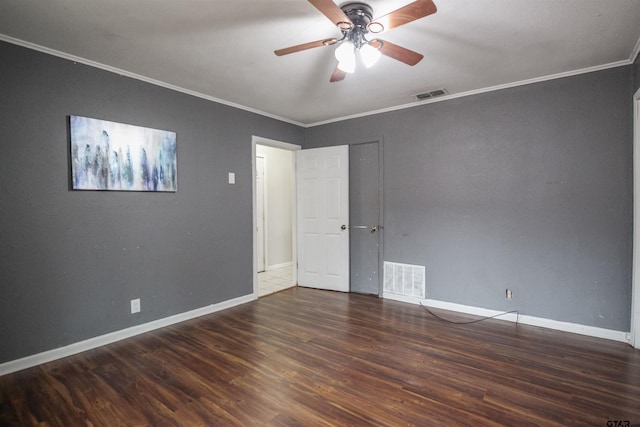 spare room with dark wood-type flooring, ceiling fan, and ornamental molding