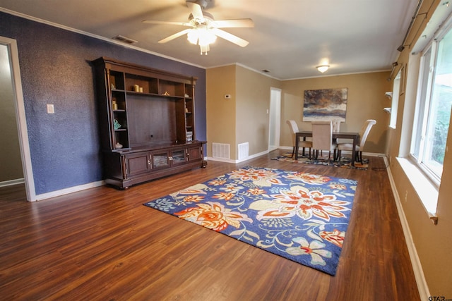 living room with hardwood / wood-style floors, crown molding, and ceiling fan