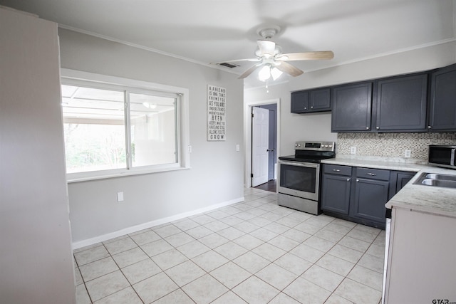 kitchen featuring decorative backsplash, ornamental molding, light tile patterned floors, ceiling fan, and stainless steel appliances