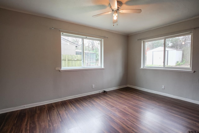 empty room featuring ornamental molding, ceiling fan, and dark hardwood / wood-style flooring