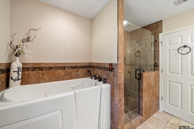 full bathroom with tile walls, visible vents, marble finish floor, a shower stall, and a garden tub
