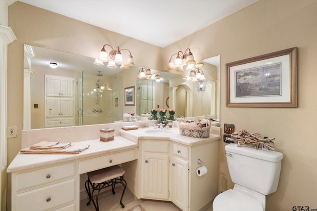 bathroom featuring tile patterned floors, toilet, an inviting chandelier, a shower stall, and vanity