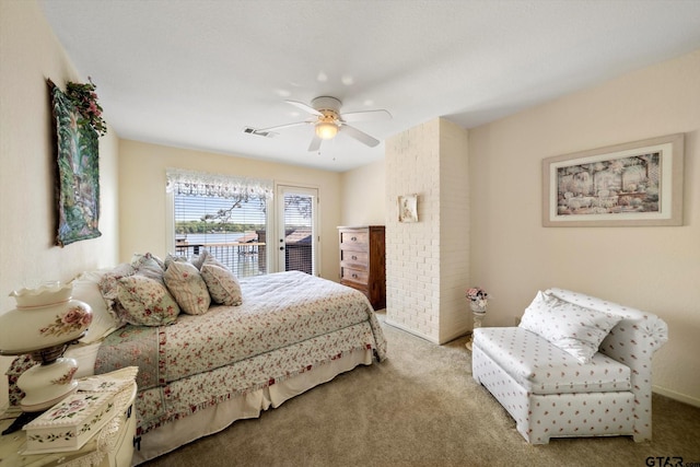 carpeted bedroom featuring ceiling fan, access to exterior, and visible vents