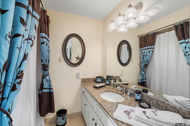 bathroom featuring baseboards and vanity