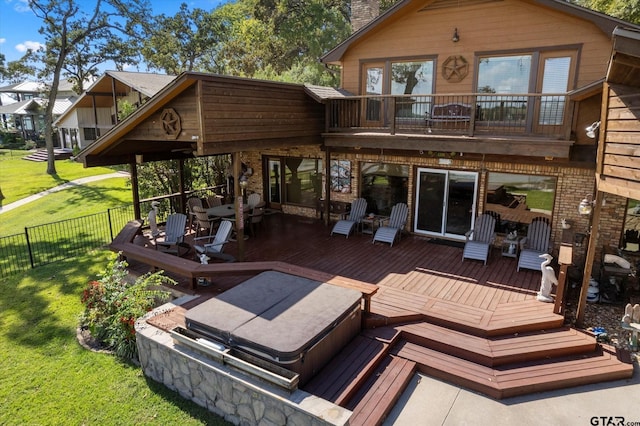 back of house featuring a chimney, fence, a wooden deck, a balcony, and a yard