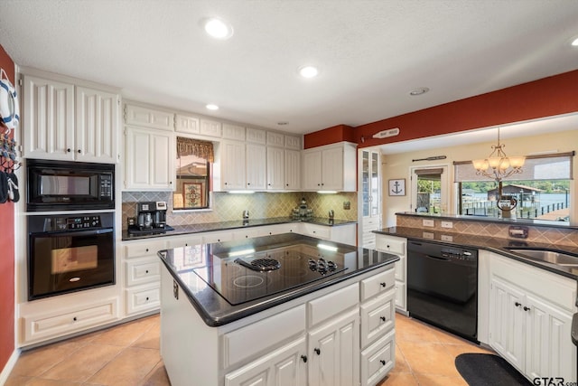 kitchen with black appliances, dark countertops, and tasteful backsplash
