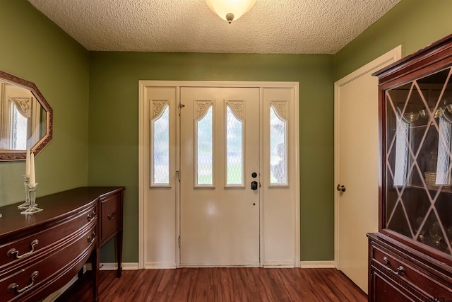 6001 Huntington Dr, Tyler, TX 75703 - foyer with dark wood-style floors, a textured ceiling, and baseboards