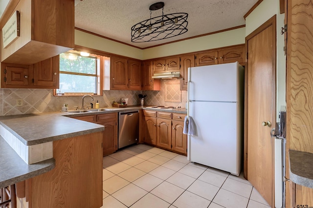 6001 Huntington Dr, Tyler, TX 75703 - kitchen featuring white appliances, a sink, under cabinet range hood, brown cabinetry, and a textured ceiling