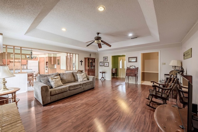 6001 Huntington Dr, Tyler, TX 75703 - living room with a raised ceiling, a textured ceiling, wood finished floors, ceiling fan, and recessed lighting
