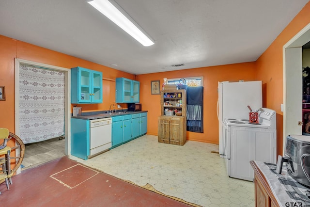 kitchen featuring blue cabinetry, white appliances, washer / dryer, and sink