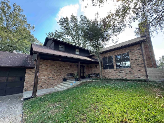 view of front of home with a garage and a front yard