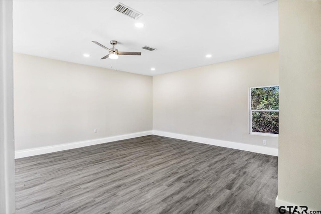 spare room featuring dark hardwood / wood-style floors and ceiling fan