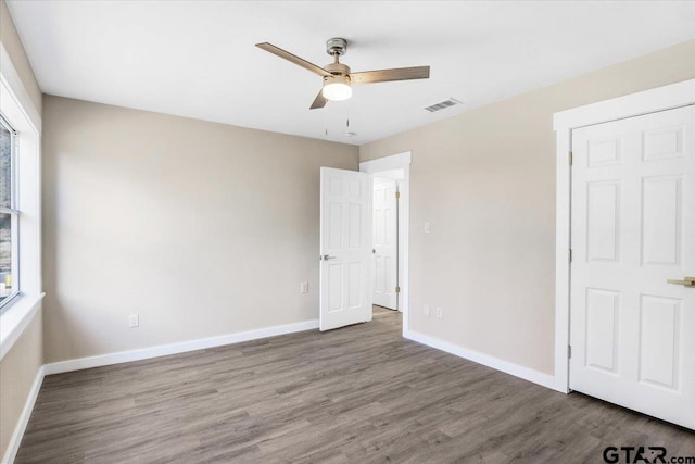 unfurnished bedroom with wood-type flooring and ceiling fan