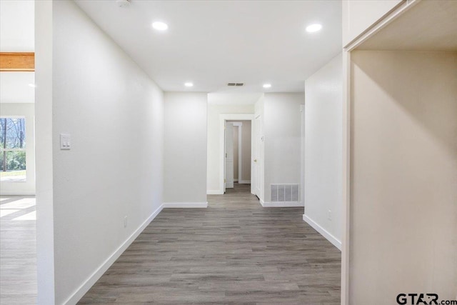 corridor with hardwood / wood-style flooring