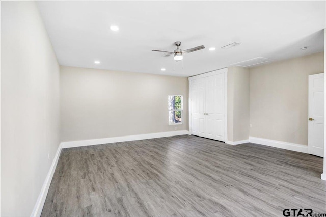 empty room featuring ceiling fan and hardwood / wood-style flooring