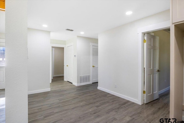 unfurnished room with dark wood-type flooring