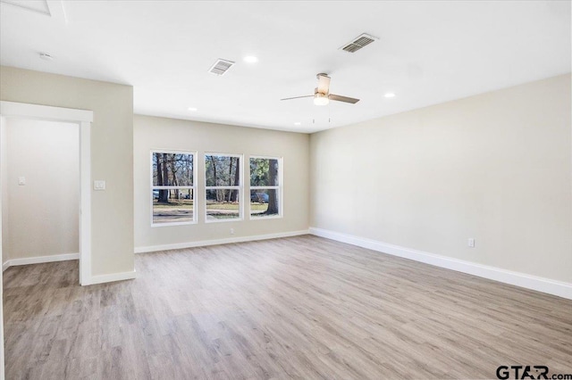 empty room featuring ceiling fan and light hardwood / wood-style flooring