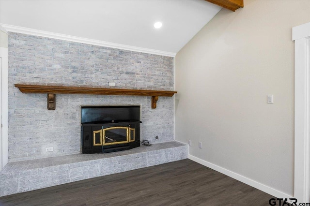 room details with beam ceiling, crown molding, wood-type flooring, and a brick fireplace