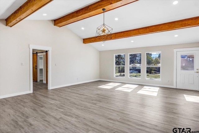 unfurnished living room featuring wood-type flooring and lofted ceiling with beams