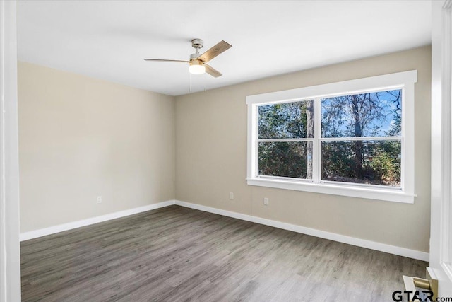 spare room featuring ceiling fan and hardwood / wood-style flooring