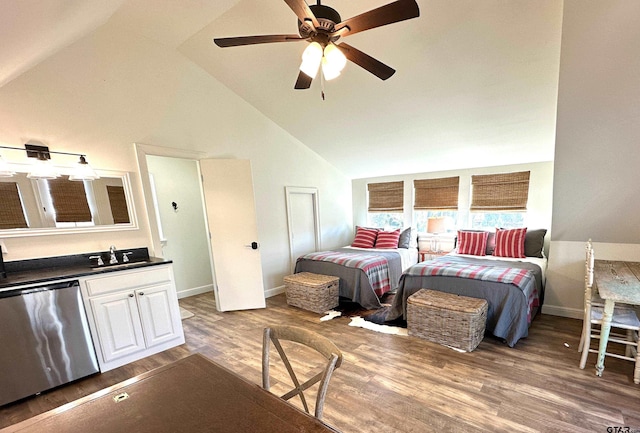 bedroom with a sink, baseboards, high vaulted ceiling, and wood finished floors