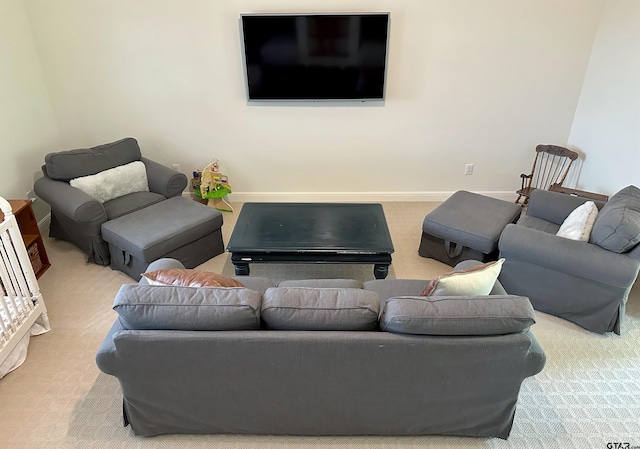 living area featuring carpet floors and baseboards