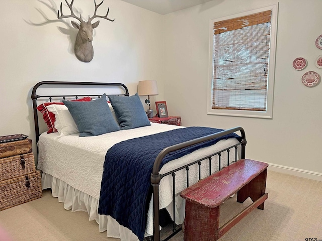 bedroom with carpet and baseboards