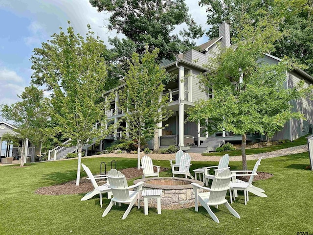 view of yard with stairway and a fire pit