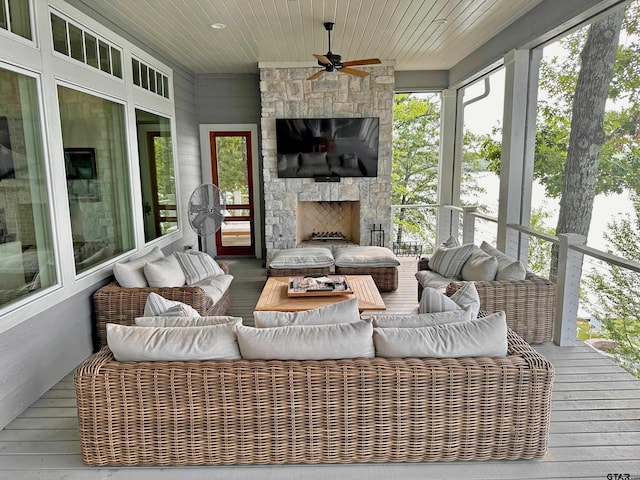 sunroom with wooden ceiling, a fireplace, and plenty of natural light