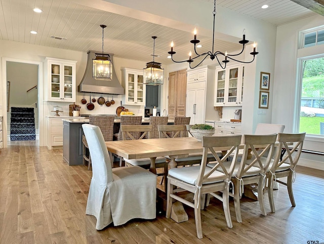 dining space featuring wood ceiling, stairs, and light wood-style flooring