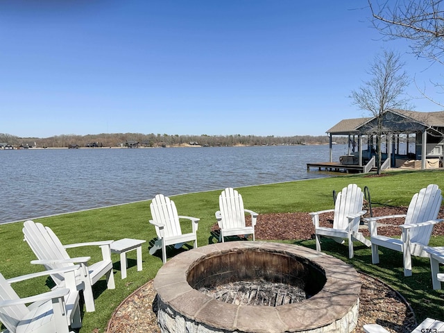 view of patio / terrace with a water view and a fire pit