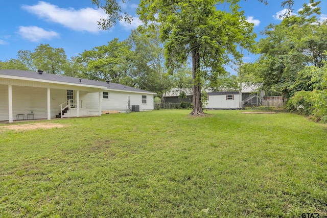 view of yard with a storage shed, central AC, an outdoor structure, and a fenced backyard