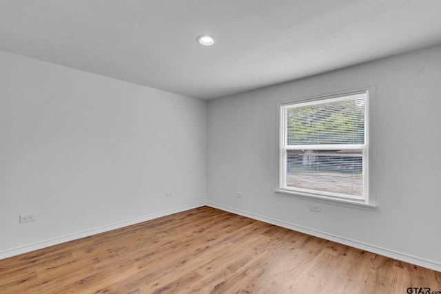 unfurnished room featuring recessed lighting, baseboards, and light wood-style flooring