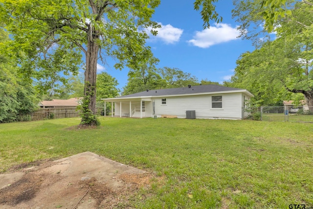 back of house with a lawn, a fenced backyard, central air condition unit, and a patio