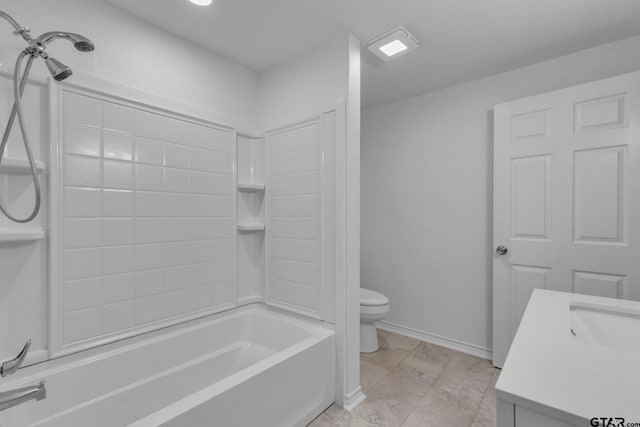 bathroom featuring vanity, toilet, marble finish floor, baseboards, and tub / shower combination